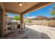 Covered backyard patio with stainless steel grill, built-in bar, and a pool and spa at 8244 Cupertino Heights Way, Las Vegas, NV 89178