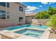 Luxurious backyard pool and spa with stone accents, lush landscaping, and a private oasis at 8244 Cupertino Heights Way, Las Vegas, NV 89178