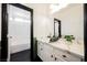 Bright bathroom with dark hardwood floors and a marble countertop at 8244 Cupertino Heights Way, Las Vegas, NV 89178