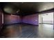 Large bonus room with sleek wood floors, stylish purple walls, and modern lighting at 8244 Cupertino Heights Way, Las Vegas, NV 89178