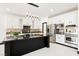 Modern kitchen featuring white cabinets, stainless steel appliances, and a granite island at 8244 Cupertino Heights Way, Las Vegas, NV 89178