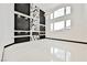 Modern open living space featuring a fireplace, stylish shelves, and large windows at 8244 Cupertino Heights Way, Las Vegas, NV 89178