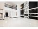 Open-concept living room with a modern fireplace, stylish shelves, and soaring ceilings at 8244 Cupertino Heights Way, Las Vegas, NV 89178