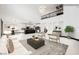 Bright, open-concept living space boasts modern decor, a soaring ceiling, and seamless transition to the kitchen at 8244 Cupertino Heights Way, Las Vegas, NV 89178