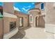 Charming outdoor patio with fireplace and cozy seating area, perfect for entertaining guests at 8244 Cupertino Heights Way, Las Vegas, NV 89178