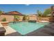 Backyard pool features stone accents, clear blue water, and space to relax at 8244 Cupertino Heights Way, Las Vegas, NV 89178