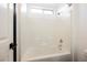 Bathroom shower with a white tile surround and a window above at 8244 Cupertino Heights Way, Las Vegas, NV 89178