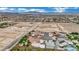 Community aerial showcasing desert homes, construction sites, and a mountain backdrop, perfect for a peaceful lifestyle at 9180 Mohawk St, Las Vegas, NV 89139