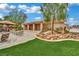 Landscaped backyard features a dining area, artificial grass, patio, and desert landscaping at 9180 Mohawk St, Las Vegas, NV 89139
