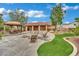 Spacious backyard with dining area, fire pit, artificial grass, patio, and desert landscaping at 9180 Mohawk St, Las Vegas, NV 89139