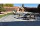 Large backyard with a stone patio, outdoor seating, and decorative rock features providing a peaceful oasis at 9180 Mohawk St, Las Vegas, NV 89139