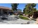Spacious backyard featuring a stone patio, mature trees, and an outdoor seating area perfect for relaxation at 9180 Mohawk St, Las Vegas, NV 89139
