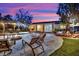 Spectacular backyard at dusk featuring a fire pit, covered patio, and serene ambience at 9180 Mohawk St, Las Vegas, NV 89139