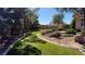 Lush backyard showcasing green synthetic grass, mature landscaping, and a well-maintained garden at 9180 Mohawk St, Las Vegas, NV 89139