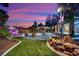 Inviting backyard featuring a stone patio, waterfall, fire pit, and gazebo that provides ample space for outdoor enjoyment at 9180 Mohawk St, Las Vegas, NV 89139