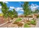 Lush backyard features a rock waterfall, dining area, fire pit, and mature landscaping at 9180 Mohawk St, Las Vegas, NV 89139