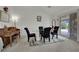 Dining area with glass table, chairs and carpeted floor adjacent to a sliding door at 9180 Mohawk St, Las Vegas, NV 89139