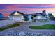 Beautiful home with a two-car garage, landscaped yard, and inviting curb appeal under a colorful sunset at 9180 Mohawk St, Las Vegas, NV 89139