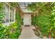 Charming entrance with lush greenery creating a welcoming and private approach to the front door at 9180 Mohawk St, Las Vegas, NV 89139