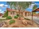 Charming home with a well-maintained front yard featuring mature landscaping and a covered porch at 9180 Mohawk St, Las Vegas, NV 89139