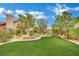 Inviting front yard with lush green lawn and manicured landscaping, creating curb appeal at 9180 Mohawk St, Las Vegas, NV 89139