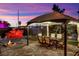 Charming gazebo with outdoor seating and a fire pit is a perfect spot to unwind while enjoying the sunset views at 9180 Mohawk St, Las Vegas, NV 89139