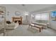 Bright and airy living room featuring a fireplace, comfortable seating, and a large window for natural light at 9180 Mohawk St, Las Vegas, NV 89139