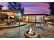 Inviting patio with stone flooring, fire pit, and covered dining area, ideal for outdoor entertaining at 9180 Mohawk St, Las Vegas, NV 89139