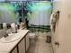 Clean bathroom with a serene shower curtain, white sink, and modern fixtures at 9611 Sky Hollow Dr, Las Vegas, NV 89123