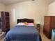 Cozy bedroom featuring a comfortable bed, wooden bookcase, and a classic wardrobe at 9611 Sky Hollow Dr, Las Vegas, NV 89123