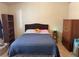 Relaxing bedroom with a queen bed, storage cabinet, and natural light at 9611 Sky Hollow Dr, Las Vegas, NV 89123