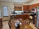 Well-lit kitchen featuring stainless steel appliances, wood cabinets, and a cozy dining space at 9611 Sky Hollow Dr, Las Vegas, NV 89123