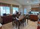 Functional kitchen with wood cabinetry, tile flooring, and a dining area perfect for Gathering meals at 9611 Sky Hollow Dr, Las Vegas, NV 89123