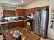 Efficient kitchen featuring stainless steel appliances, wooden cabinetry, and a built-in pantry for storage at 9611 Sky Hollow Dr, Las Vegas, NV 89123