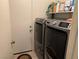 Functional laundry room with modern washer and dryer units and ample storage space at 9611 Sky Hollow Dr, Las Vegas, NV 89123