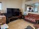 Inviting living room with tile floors and a large flatscreen television for cozy evenings at 9611 Sky Hollow Dr, Las Vegas, NV 89123