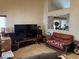 Comfortable living room showcasing tile flooring, a large TV, and a cozy seating arrangement at 9611 Sky Hollow Dr, Las Vegas, NV 89123