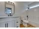 Bathroom featuring modern vanity, dark hardware, bathtub, and tile walls at 9855 Ashton Pines Ct, Las Vegas, NV 89147