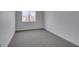 Bedroom with carpet floors, white walls and a single window at 9855 Ashton Pines Ct, Las Vegas, NV 89147