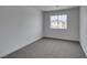 Bedroom with carpet floors, white walls and view to neighborhood at 9855 Ashton Pines Ct, Las Vegas, NV 89147