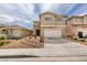 Two-story home with a two-car garage, a low maintenance front yard, and a neutral color scheme at 9855 Ashton Pines Ct, Las Vegas, NV 89147