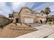 Two-story home featuring a two-car garage and minimal landscaping in the front yard at 9855 Ashton Pines Ct, Las Vegas, NV 89147