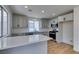 Bright kitchen features white cabinets, stainless steel appliances, quartz counters, and modern fixtures at 9855 Ashton Pines Ct, Las Vegas, NV 89147