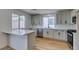 Modern kitchen with white cabinets, quartz countertops, subway tile backsplash, and stainless steel appliances at 9855 Ashton Pines Ct, Las Vegas, NV 89147