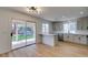 Modern kitchen with stainless steel appliances, white cabinets, peninsula, and sliding glass door to backyard at 9855 Ashton Pines Ct, Las Vegas, NV 89147