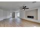 Inviting living room with wood floors, fireplace, and large windows at 9855 Ashton Pines Ct, Las Vegas, NV 89147
