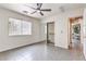 Bright bedroom features tile floors, a large window, closet and neutral paint at , Pahrump, NV 89061