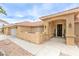 Inviting front entrance with arched entryway, mature landscaping, and a charming aesthetic at , Pahrump, NV 89061