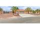 Inviting single-story home with a three-car garage, desert landscaping, and appealing curb appeal at , Pahrump, NV 89061