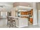 Charming kitchen featuring a breakfast bar, tile countertops, and wood cabinetry at , Pahrump, NV 89061
